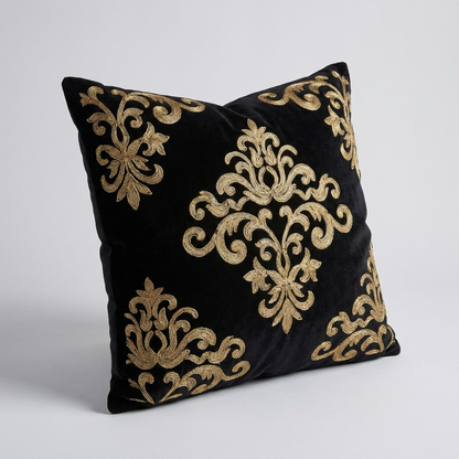 Black velvet pillow cover, angled view showing the raised gold stitching