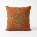 Burnt-orange linen pillow cover with antique gold embroidery, front view