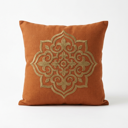 Burnt-orange linen pillow cover with antique gold embroidery, front view